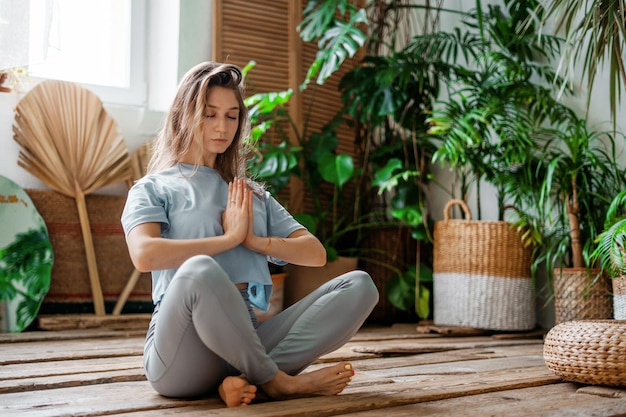 A sporty woman does exercises Yoga asana in a fitness studio A balance of fortitude and a healthy