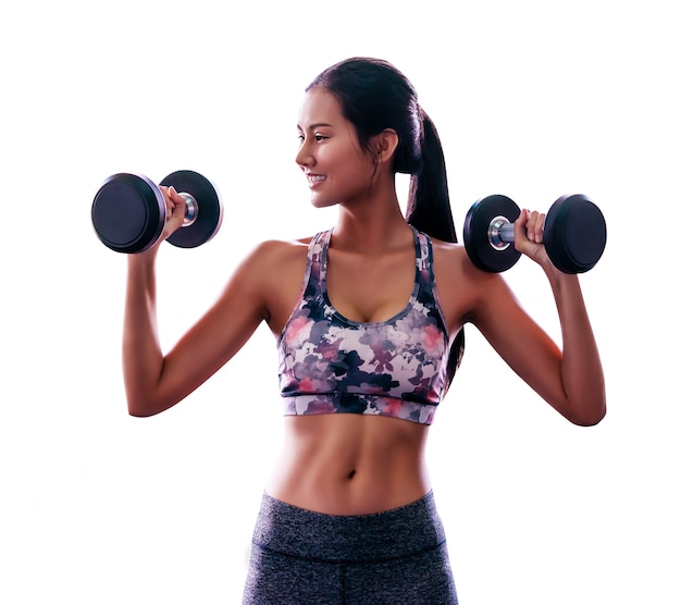 Sporty woman is holding fitness dumbbell with smile working out isolated on white.