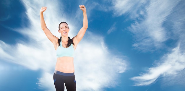 Sporty woman raising her arms