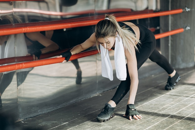 Sporty woman training morning workout in the gym. Young woman doing gym workout in the gym. Healthy and sport lifestyle