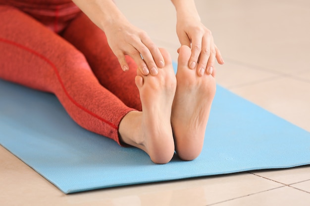 Sporty young woman practicing yoga at home