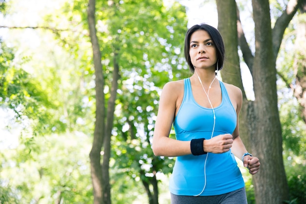 Sporty young woman running outdoors