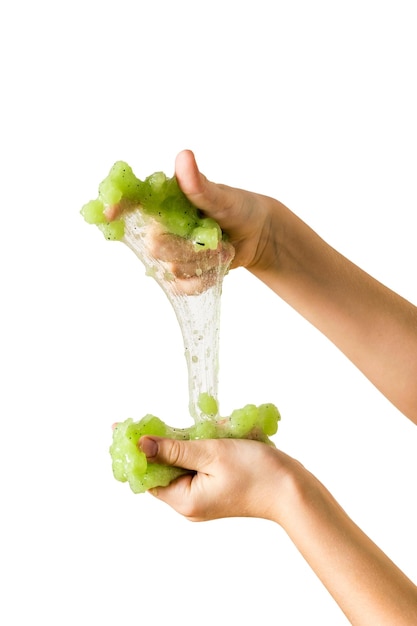 Spreading in the hands of a green lime isolated on a white background