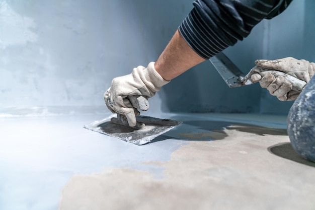 Spreading the insulation on the concrete with a trowel