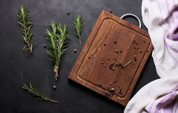 Sprigs of fresh rosemary on a black background top view