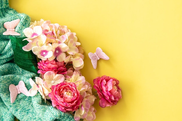 Spring background with flowers and knitted element flat lay