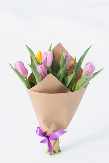 A spring bouquet of tulips in the snow International Womens Day on March 8 greeting card