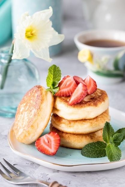 Spring Breakfast with flowers, cheesecakes and fresh berries