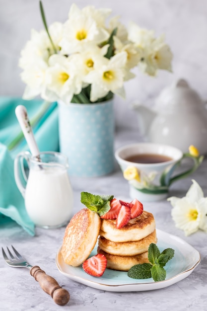 Spring Breakfast with flowers, cheesecakes and fresh berries