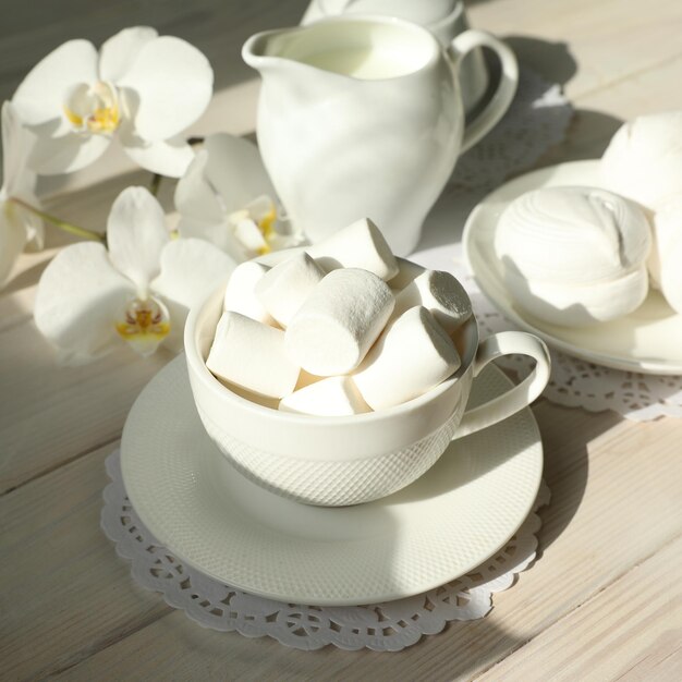 Spring breakfast with marshmallow coffee and milk Flatlay with food and flower in white color