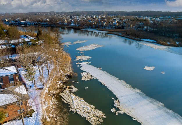 Spring early drift on beautiful river with broken off pieces on of ice float down the stream