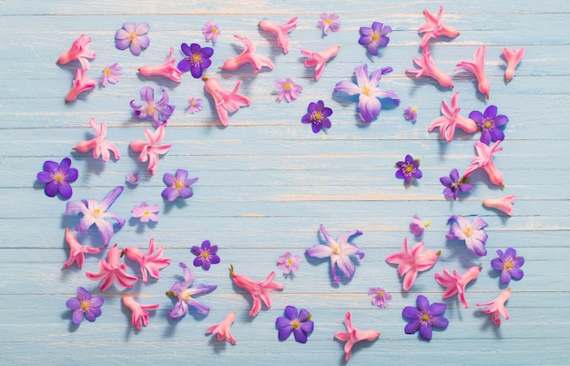 Spring flowers on old blue wooden background