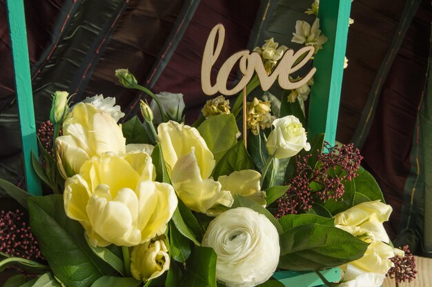 Spring flowers in wooden box and topper Love, Valentine's Day, wedding