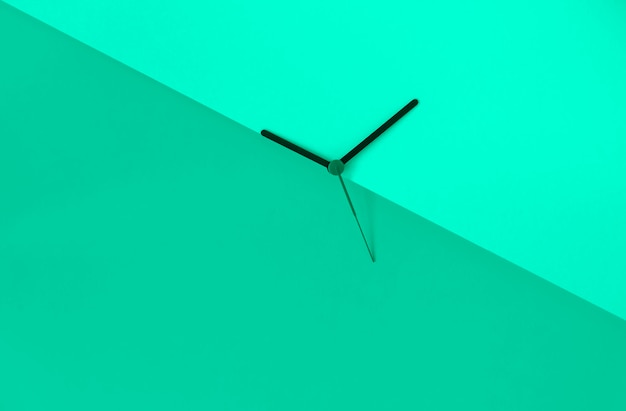 Spring forward. Clock hands on the green background 