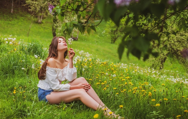 Spring happy woman sitting outdoor in summer park healthy breathing concept unity with nature spring