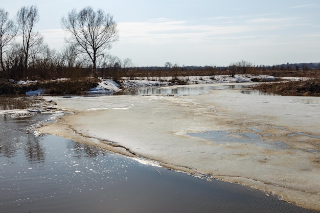 Spring ice drift on the river ice floe floating on the water spring snowmelt and flood