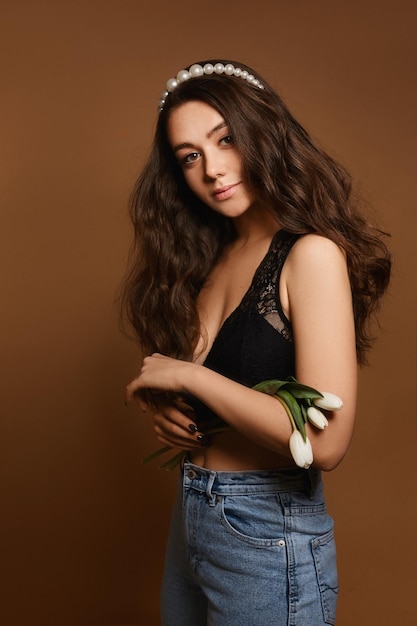 Spring lady with beautiful tulip flowers portrait of a young caucasian model woman with gentle makeu...