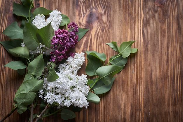 Spring May Flowers. White And Purple Lilac Flowers On Wooden Table Top View.