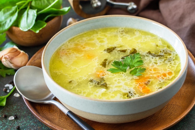 Spring menu Healthy spinach soup with cream on a dark stone countertop