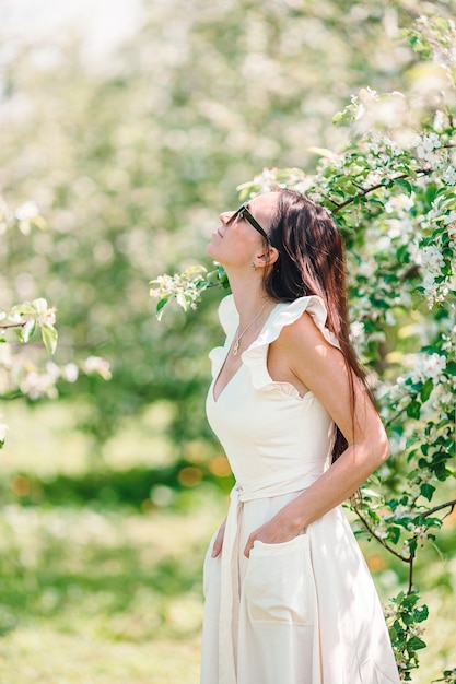 Spring mood beautiful woman smell flowering tree enjoying nature white floral garden