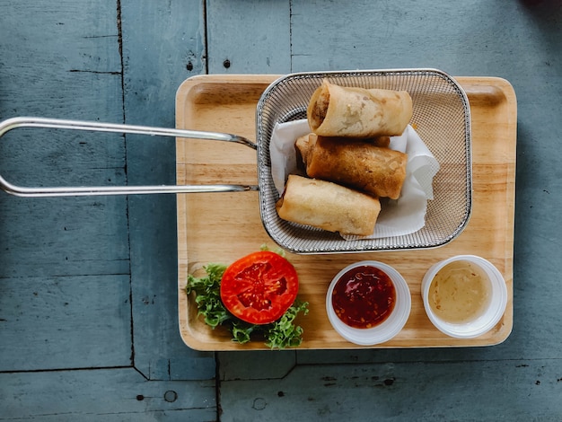 Spring rolls on rustic wooden table