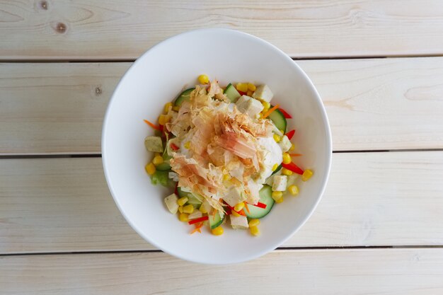 Spring salad with cucumber, bell pepper, corn and tuna chips