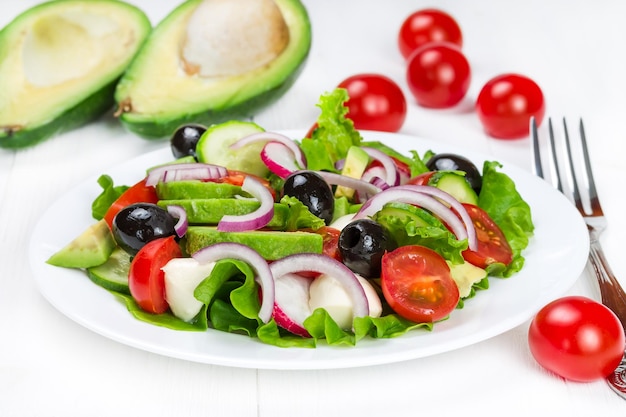 Spring salad with fresh vegetables on a white plate