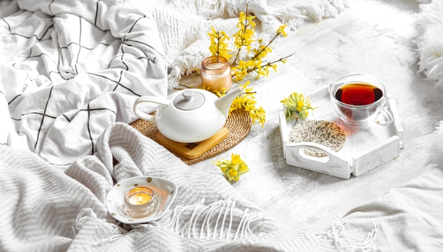 Spring still life with a Cup of tea and flowers. Light table, blooming and cozy house.