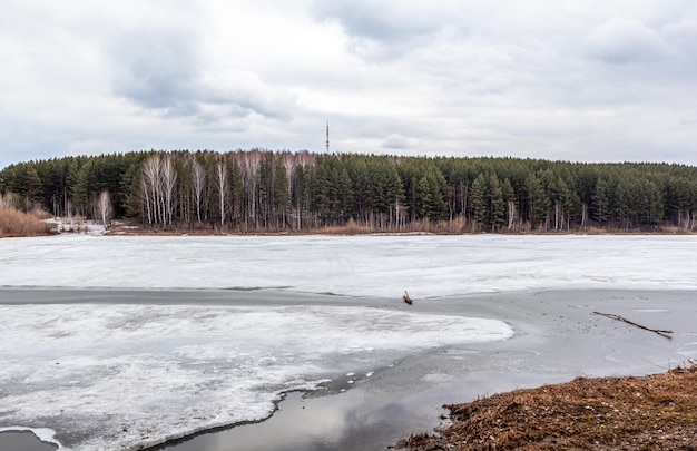 Spring streams in nature. The snow melts and clear streams run. Nature against the lakes and forests