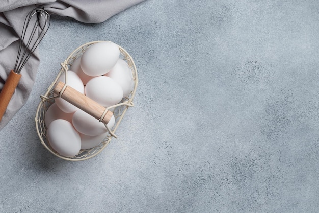 Spring time easter holidays white eggs in a basket gray table