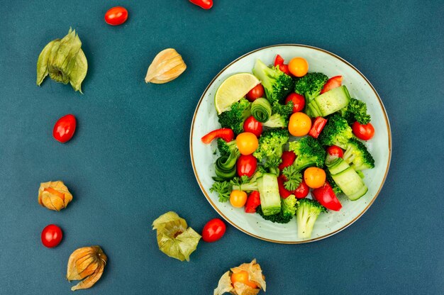 Spring vegetable salad decorated with physalis