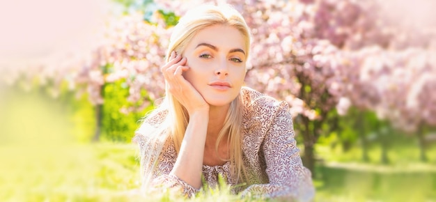 Photo spring woman face for banner beautiful girl in pink flowers in summer blossom park