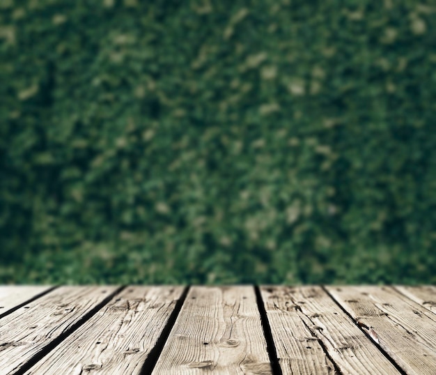 Spring wooden background with green leaves on the background