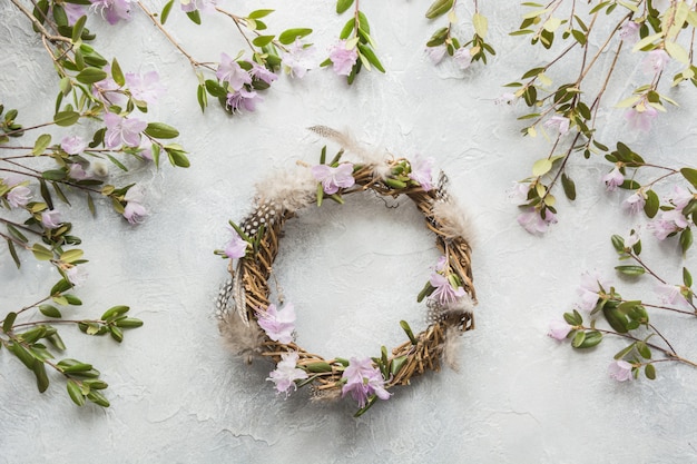 Photo spring wreath with flowers on light. creative flat lay. top view. decor handmade.