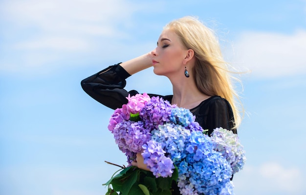 Springtime bloom Female adore flowers Spring attributes Enjoy spring without allergy Allergy free life Stop allergy blooming season Girl tender blonde hold hydrangea bouquet Pollen allergy