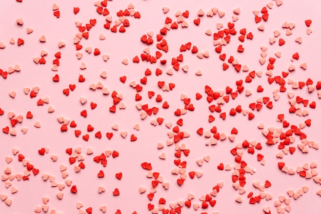 Sprinkles , sugar sprinkle red hearts, decoration. Top view, flat lay. Valentines holiday.