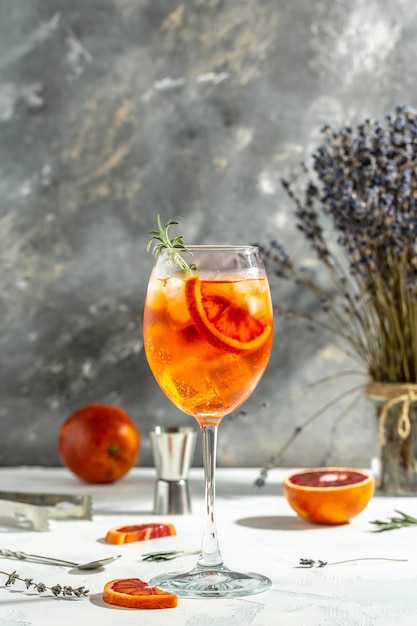 Spritz tropical aperol cocktail with with bloody oranges red bitter dry white wine soda zest and ice Summer drink