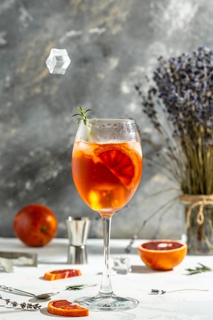 Spritz tropical aperol cocktail with with bloody oranges red bitter dry white wine soda zest and ice Summer drink