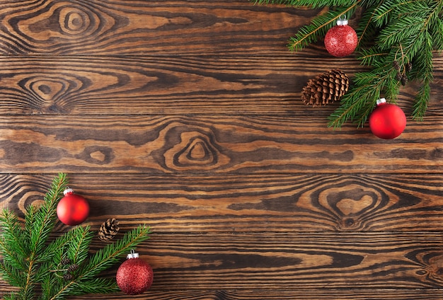 Spruce branches with Christmas balls on a wooden background Christmas and New Year