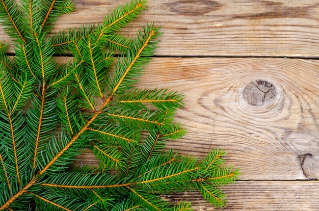 Spruce branches on wooden surface