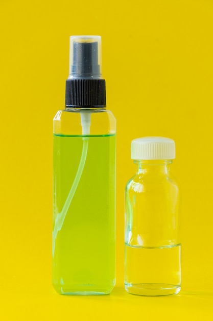 Square perfume bottle isolated on yellow background.