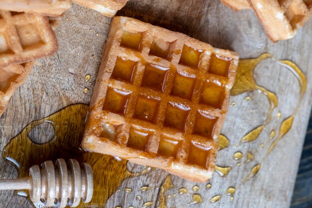 Square sweet soft waffles in bee honey