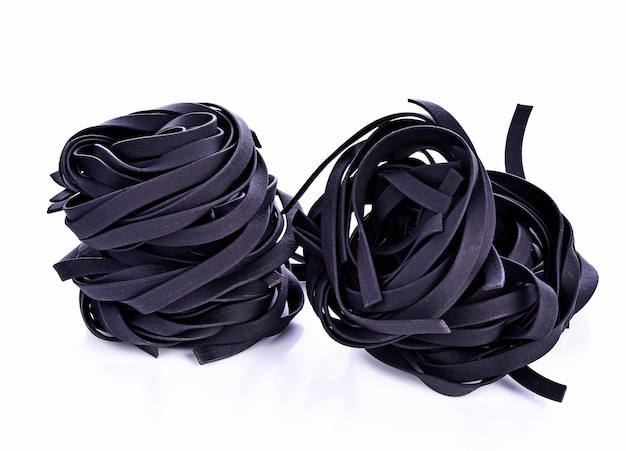 Squid ink pasta on white background