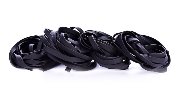 Squid ink pasta on white background