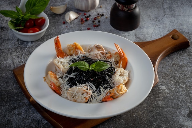 Squid ink spaghetti with seafood on the table