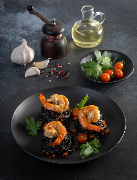 Squid ink spaghetti with shrimp on the table