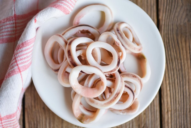 Squid rings on white plate, Fresh squid cooked boiled with for food salad on wooden background