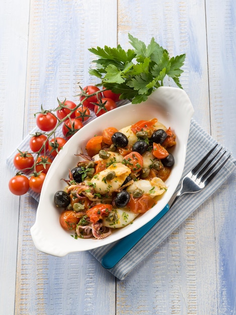 Squid with tomatoes olives and capers