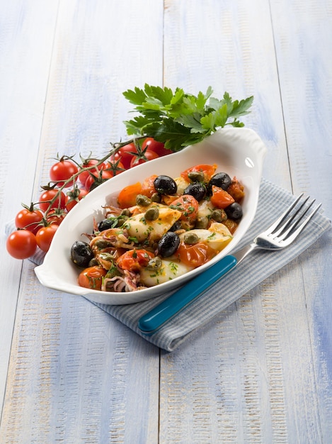 Squid with tomatoes olives and capers