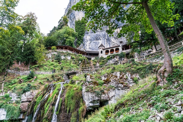 St. Beatus Cave and waterfalls above Thunersee, Sundlauenen, Switzerland.